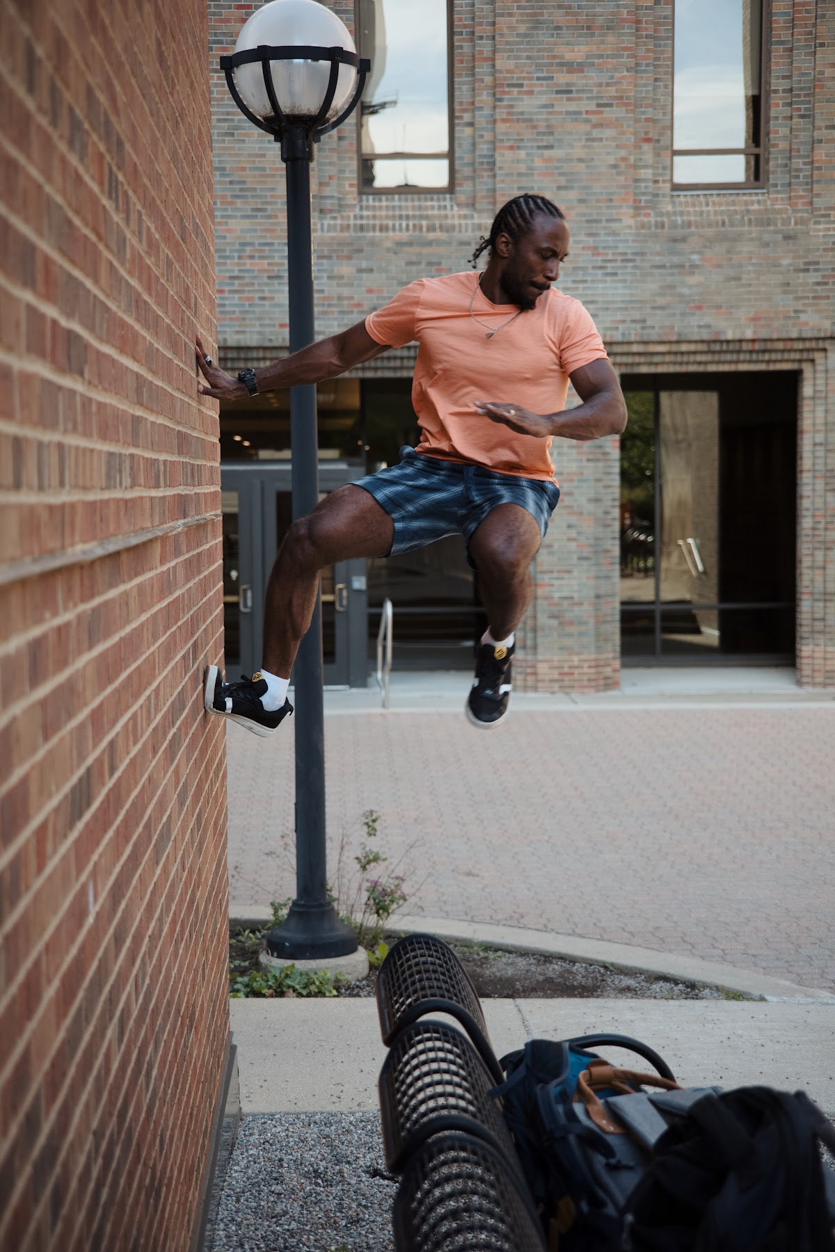 Michigan Parkour member climbing a campus wall