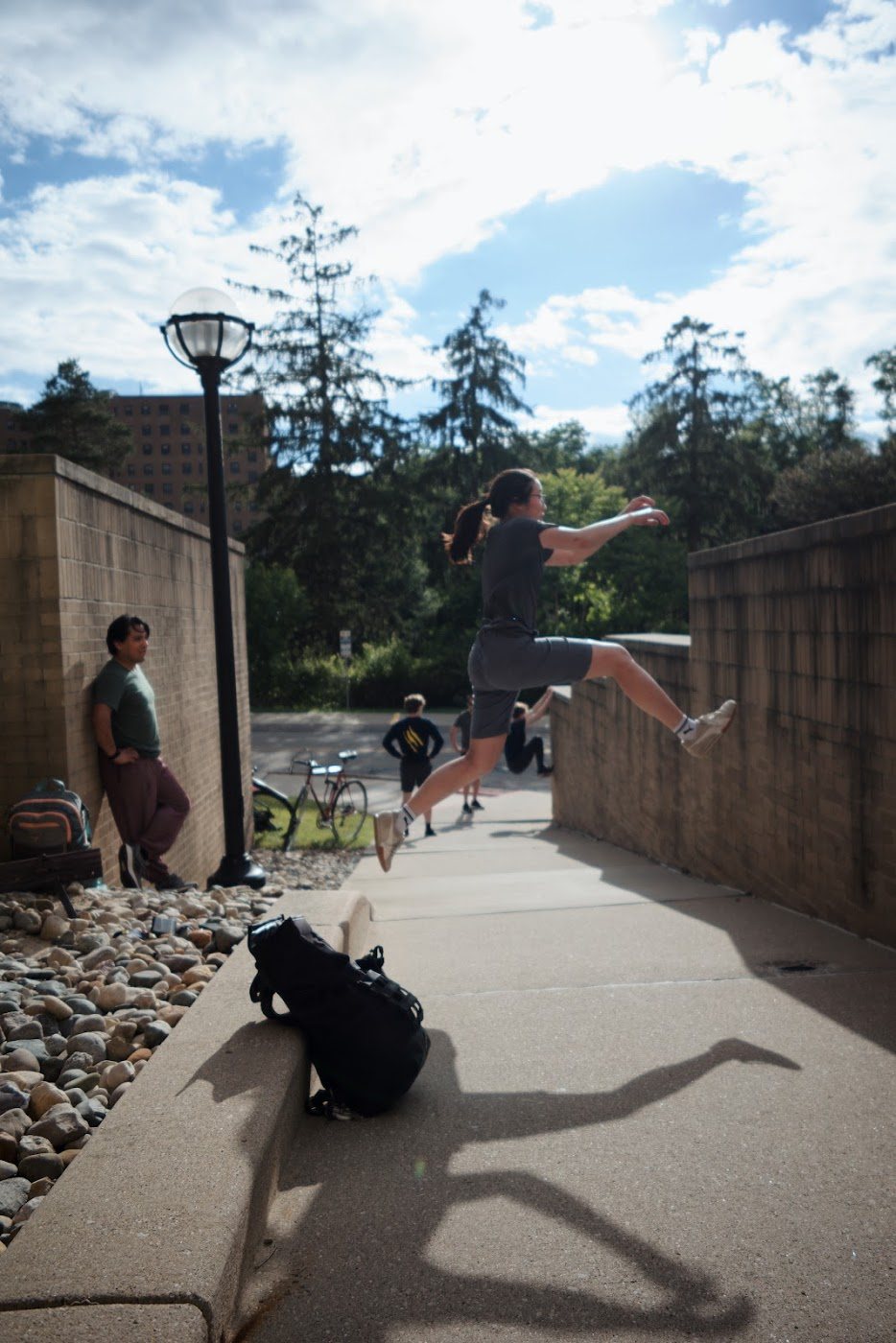 Michigan Parkour member jumping between campus walls during practice
